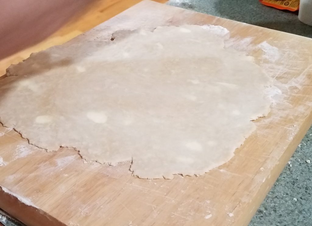 Pie dough being rolled.