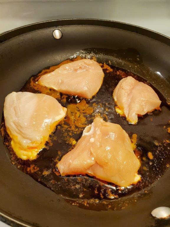 Chicken pieces searing