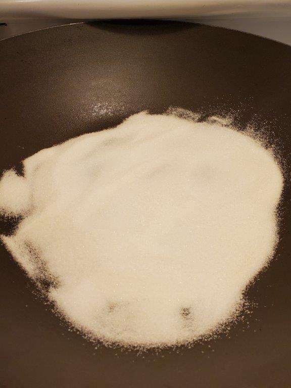 Sugar in a wok.