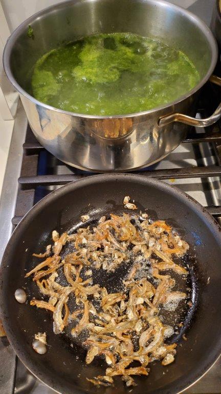 Cassava and anchovies cooking separately.